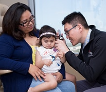 Zi Yang Jiang, M.D., with Bellemere Hernandez and her mother at a recent appointment at UT Physicians.