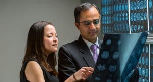 Study lead author Nitin Tandon, MD, professor in the Vivian L. Smith Department of Neurosurgery at McGovern Medical School and co-author Jessica Johnson, BSN, nurse practitioner, reviewing brain scans. (Photo credit: Memorial Hermann)