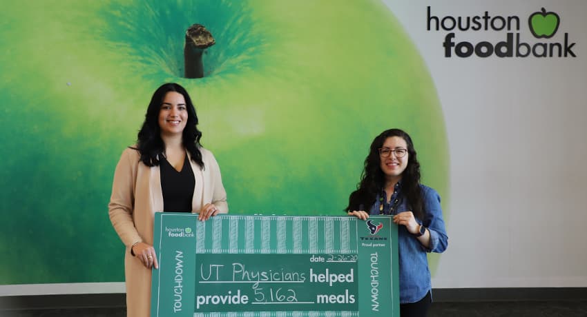 Sahar Qashqai, executive director of Healthcare Transformation Initiatives, delivers donation to the Houston Food Bank on behalf of UT Physicians.