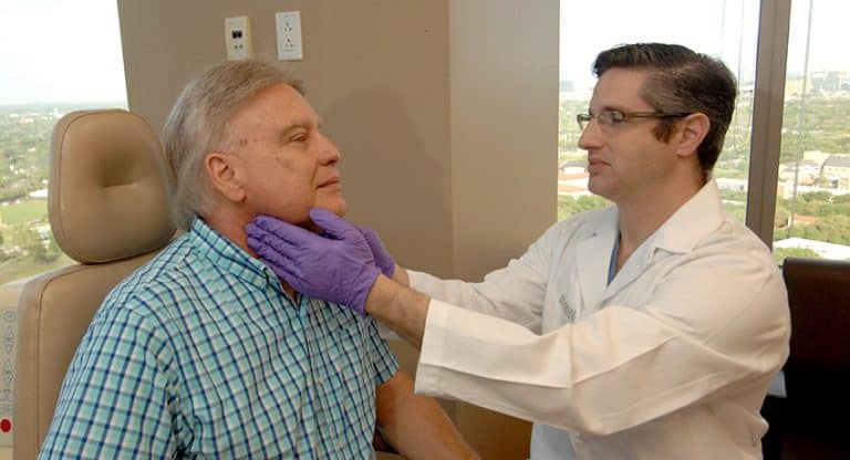 Ron J. Karni, M.D. screens patients for oral, head and neck cancer. (Photo credit: Dwight C. Andrews, UTHealth)