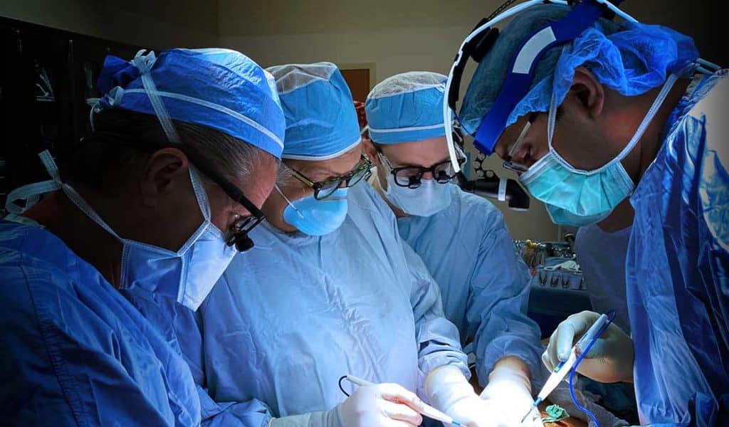 Four doctors performing general surgery