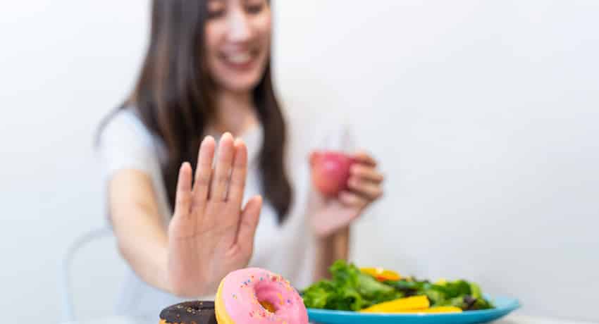 Woman refusing sugary desserts