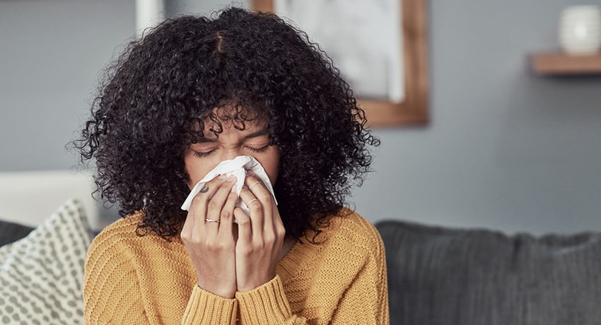 Woman sneezing