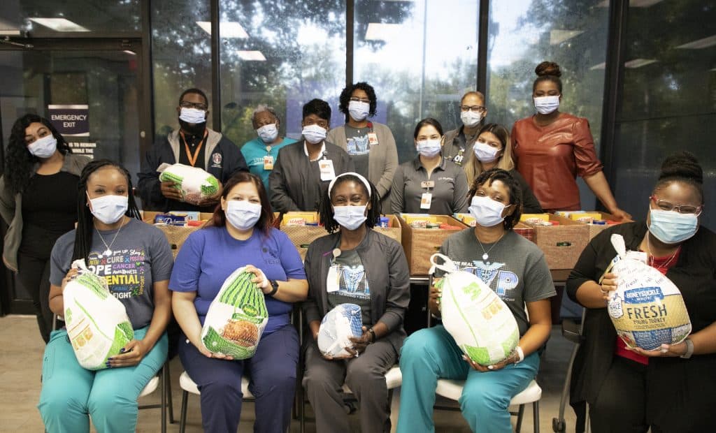 The Victory clinic staff gathered around the donations they happily purchased for their patients in need