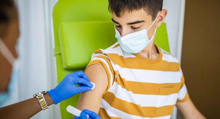 Nurse giving child a vaccine