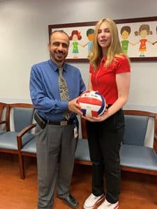 Hannah gifts Dr. Numan a volleyball
