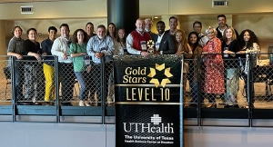 UTHealth Houston Epic team stand behind recognition banner