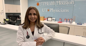 Nayab Rifat, MD, stands at the clinic front desk