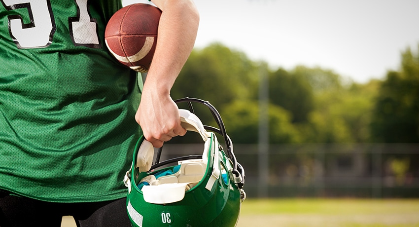 Student football player walks on the field