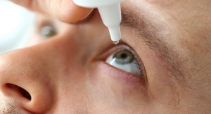 Man to drop an artificial tear in his eye