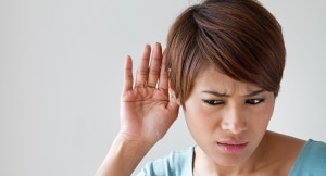 Woman gesturing hearing difficulty
