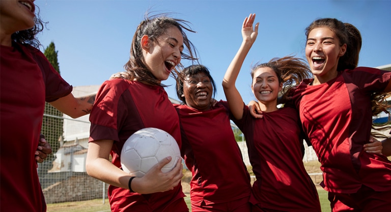 Girl soccer player huddle together