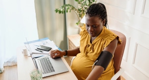 Pregnant woman checking her blood pressure