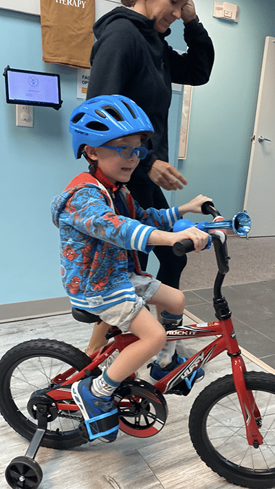 Jude riding a bike in the doctor's office