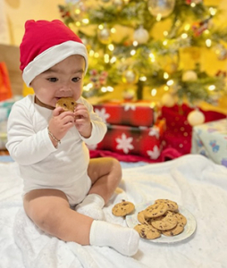 Jazael wearing Santa hat and eating a cookie