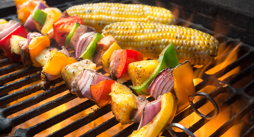 Assorted vegetables being cooked on a grill