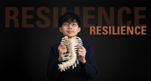 Kai Weir holding a model of his spine