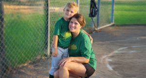 Katie Meyer with her son on a baseball field