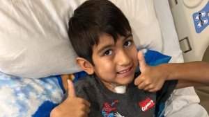 Witten Daniel gives two thumbs up after emergency surgery performed by physicians at UTHealth Houston. After the procedure he was breathing on his own, and was walking just five days later. (Photo by Casey Daniel)