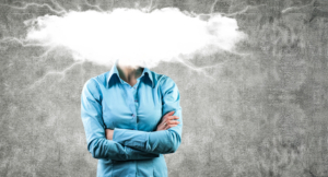 Abstract image of a female, arms crossed and head hidden in a patch of fog.