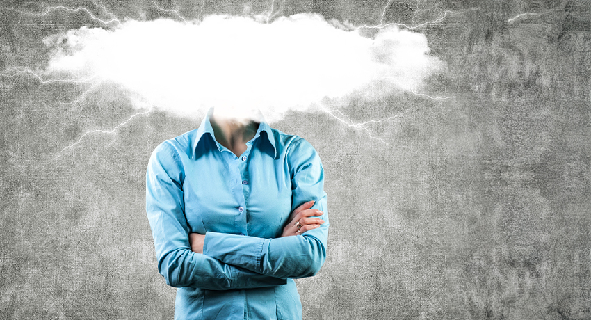 Abstract image of a female, arms crossed and head hidden in a patch of fog.