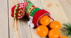 Christmas stocking with fresh oranges pouring out