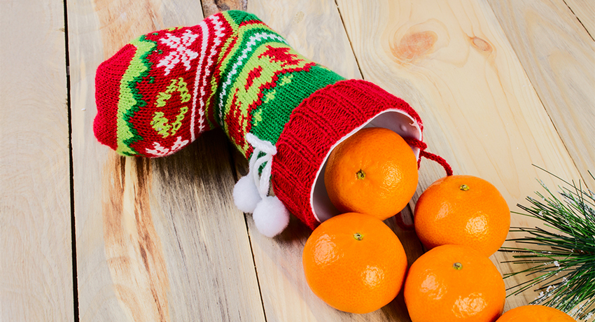 Christmas stocking with fresh oranges pouring out