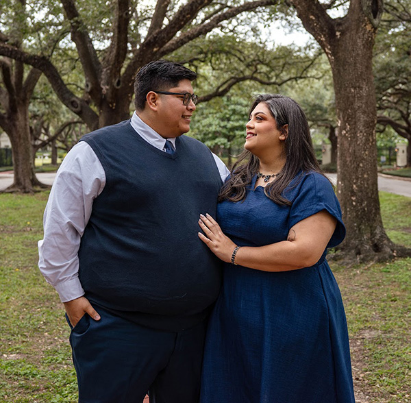 Jose and Rosie Garza Lopez standing together outside with trees in the background