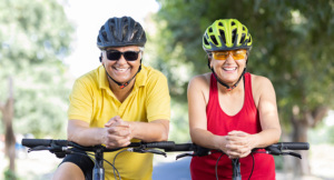 Two confident cyclists leaning on the handlebar of a bicycle outdoors