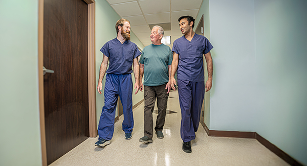 Donald and surgeons walking in a hallway