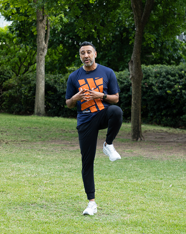 Dr. Bhojani is standing on one leg, demonstrating balance control. 