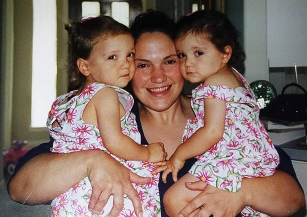 Haidar mother holding twin daughters at twenty months