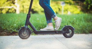 Woman riding electric scooter at the park