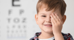 Little boy covering his eye