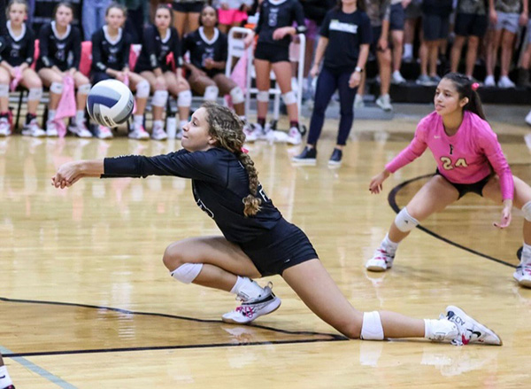 Koryn Johnson diving for a volleyball in high school