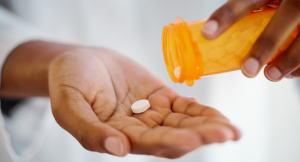 Shot of an unrecognizable person taking tablets at home