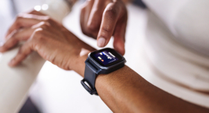 Person checks smartwatch data on their wrist