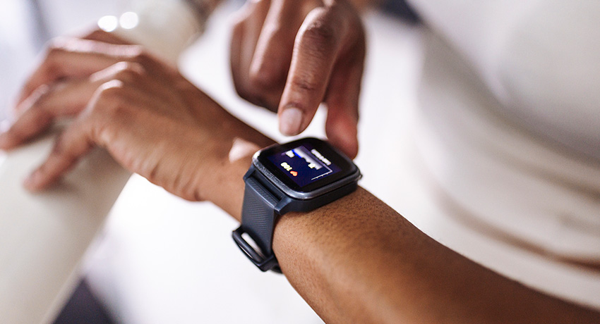Person checks smartwatch data on their wrist